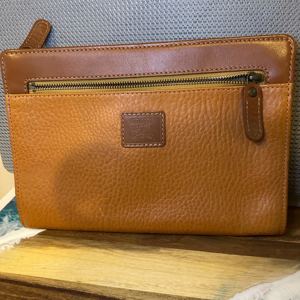 Burberry’s Vintage Tan Leather clutch.